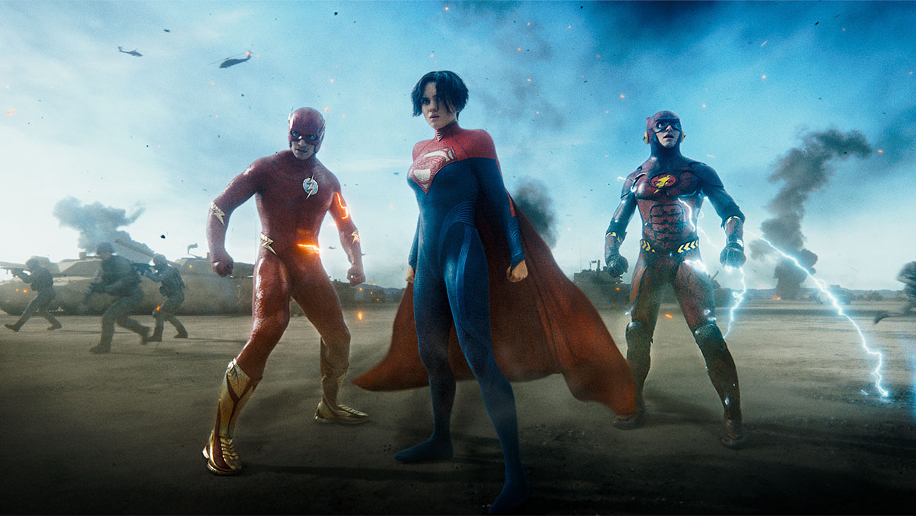 EZRA MILLER as Barry Allen The Flash, SASHA CALLE as Kara Zor-El Supergirl and EZRA MILLER as Barry Allen The Flash in action adventure 